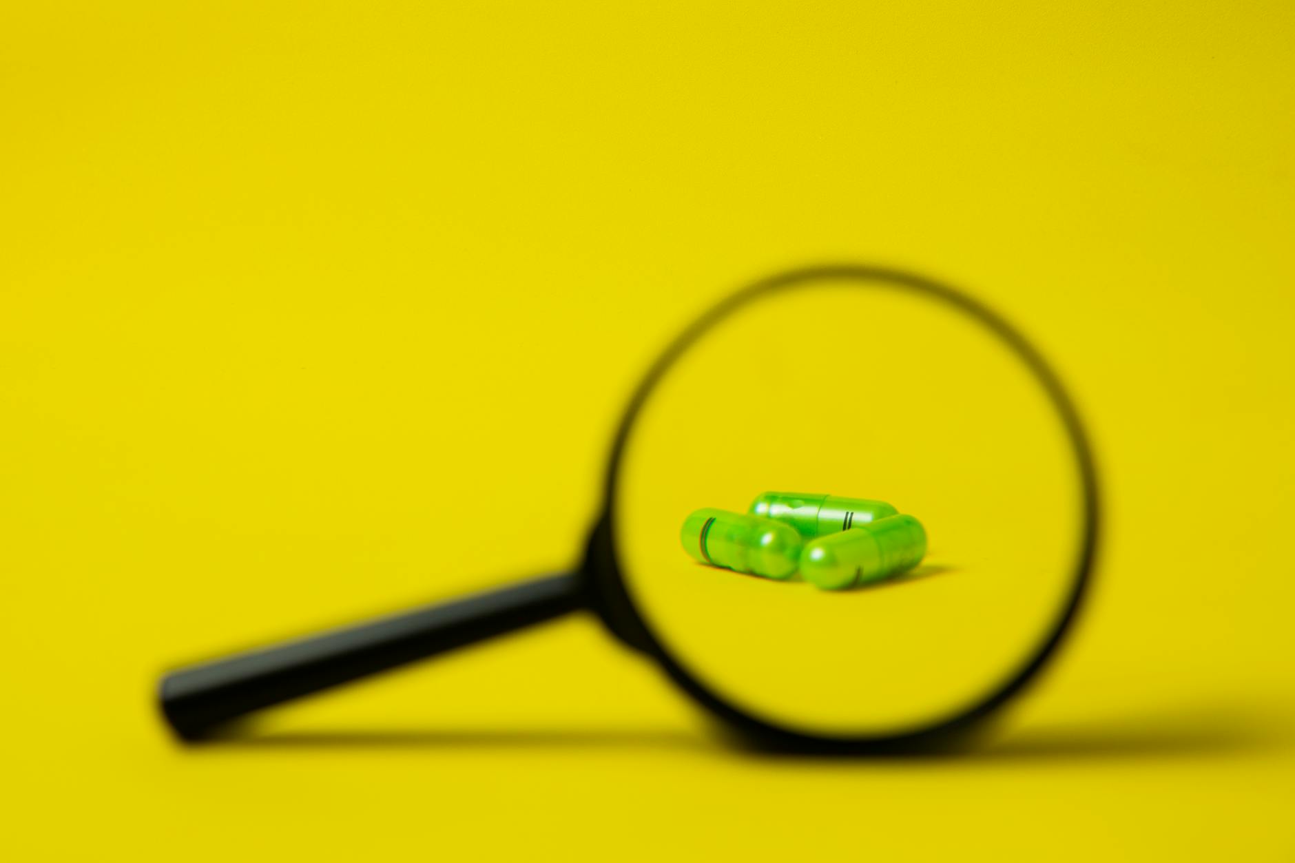 magnifier placed near green pills